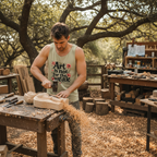 Male artist wearing Sandstone tank in outdoor wood carving studio