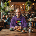 Older male in purple Kindness hoodie at coffee shop