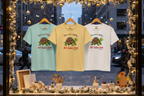 Three turtle tee variants in upscale boutique window display