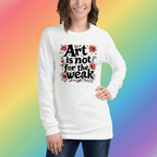 Artist wearing a tshirt that says "Art is not for the weak" on colorful background