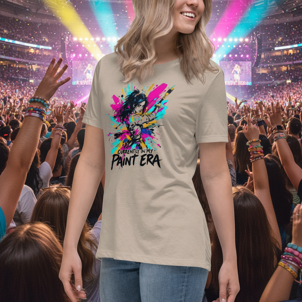 A woman wearing a "Currently in my Paint Era" tshirt at a music concert