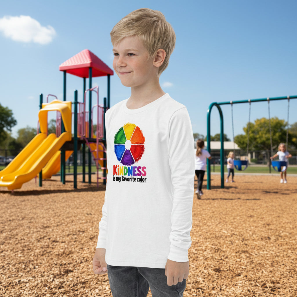 A young boy wearing a white long-sleeve t-shirt with a colorful circular graphic and the text 'KINDNESS is my favourite color' printed on the front, set against a plain white background.